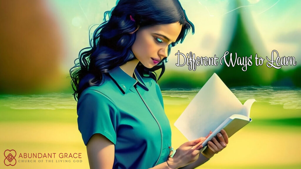 A young lady is in a park learning something by reading a book.