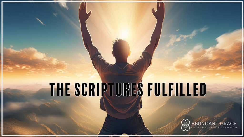 An image of A person who in kneeling on both knees with arms lifted up in the air on top of a mountain with their back facing the camera and the sun in front of them and clouds in the distance
