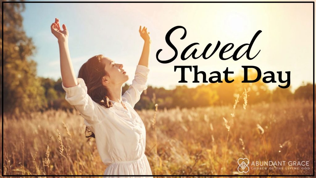 photograph of a young woman with hands lifted in the air and looking up into the sky in a field on a fall day