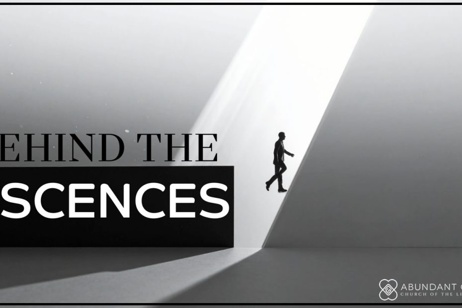 A person waling out from behind a scene