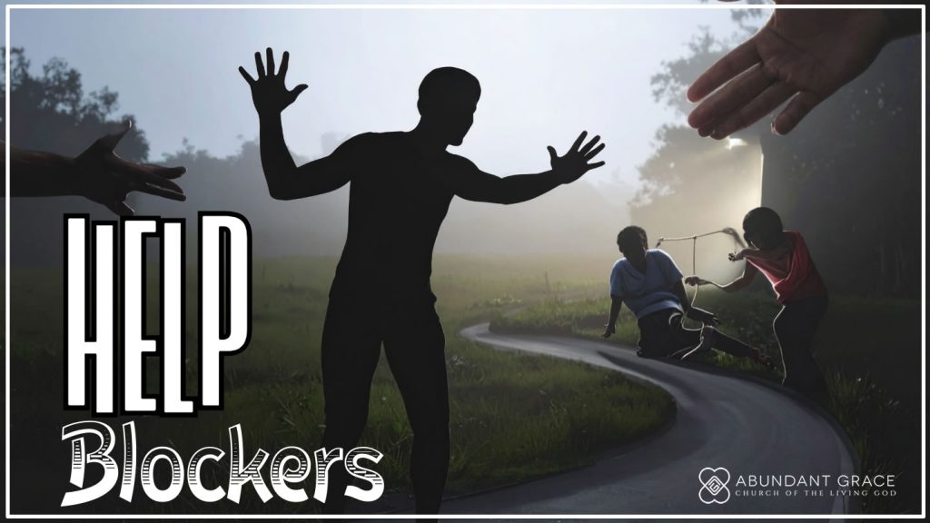 a person standing in the middle of a path with their arms stretched outward, acting as a barrier that blocks helpers from reaching someone in need further down the road. 
