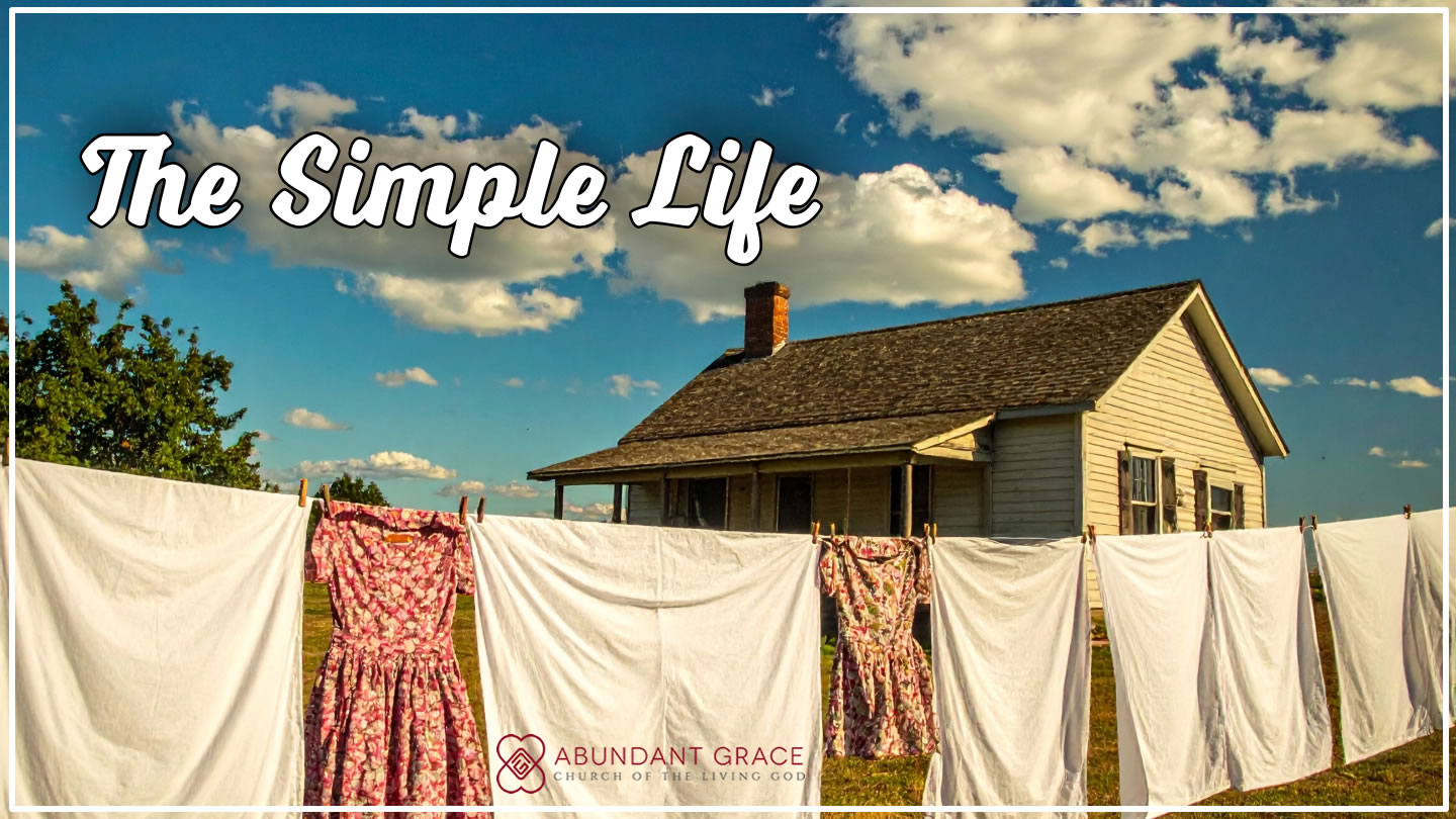 clothes drying outside on a line in the backyard of a house built in the 1960s in the country on sunny day with blue skies and white clouds.