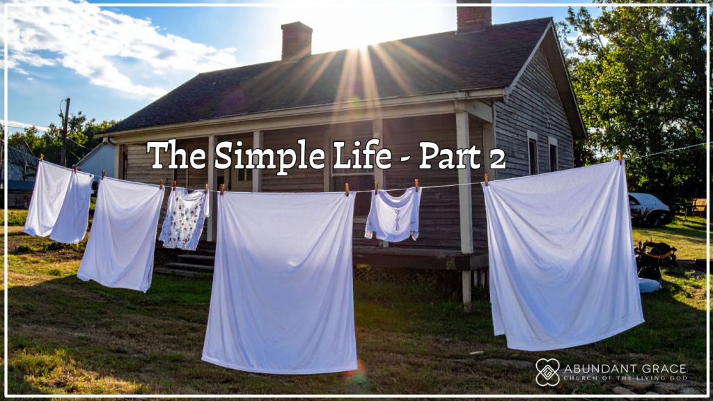 clothes drying outside on a line in the backyard of a house built in the 1960s  in the country on sunny day with blue skies and white clouds.