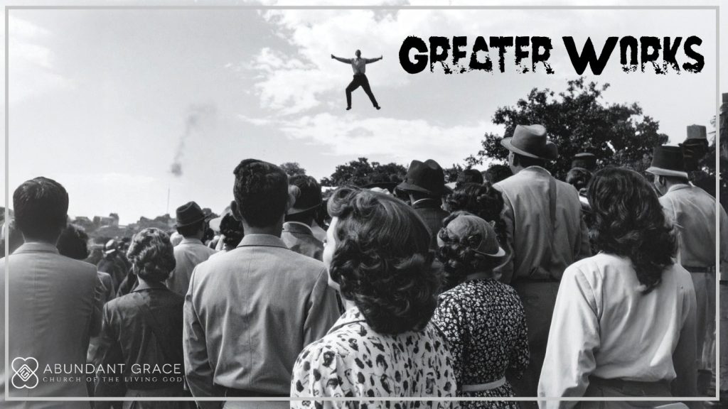 A man suspended in the air in the 1960s with a crowd watching